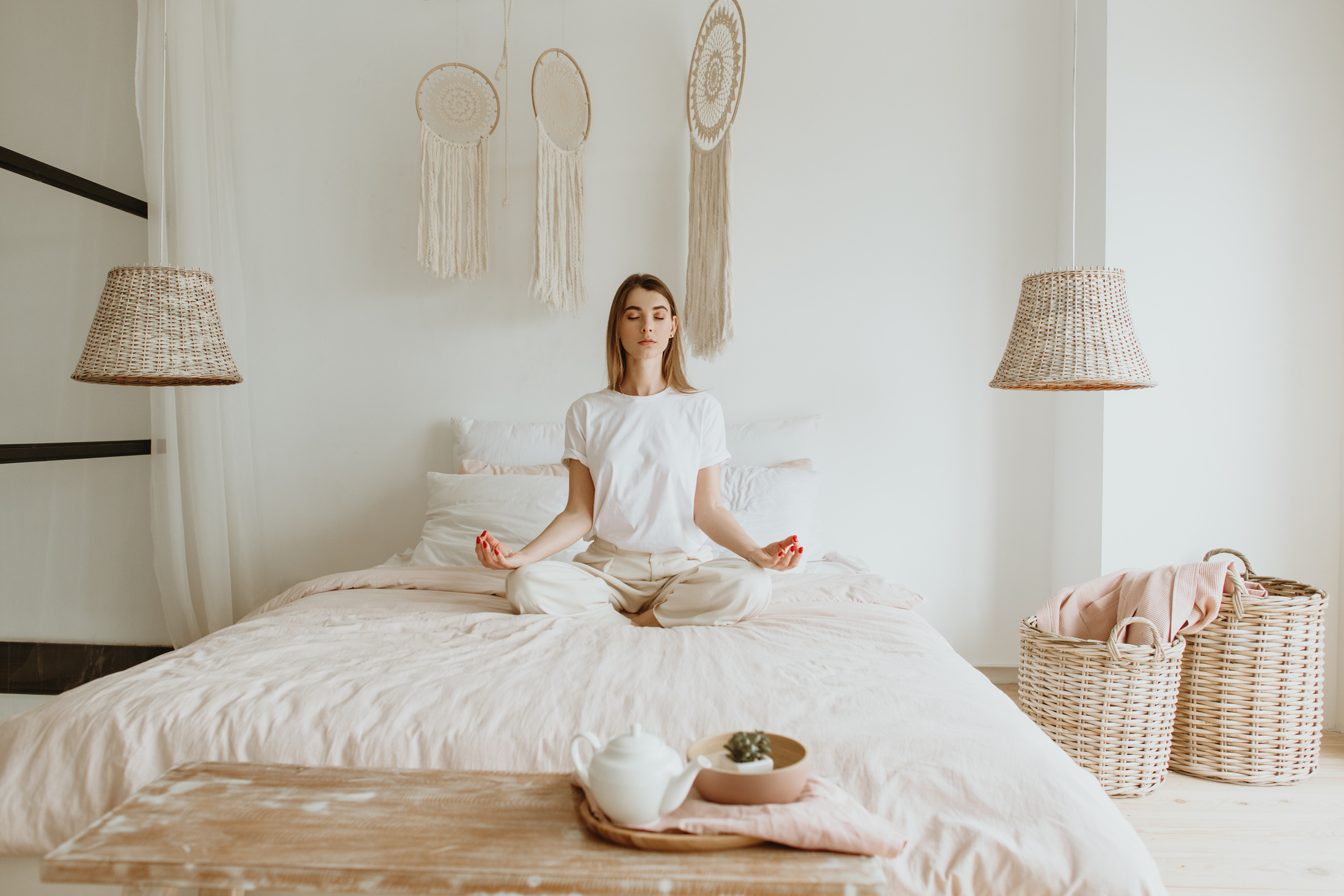 Woman practicing meditation on bed